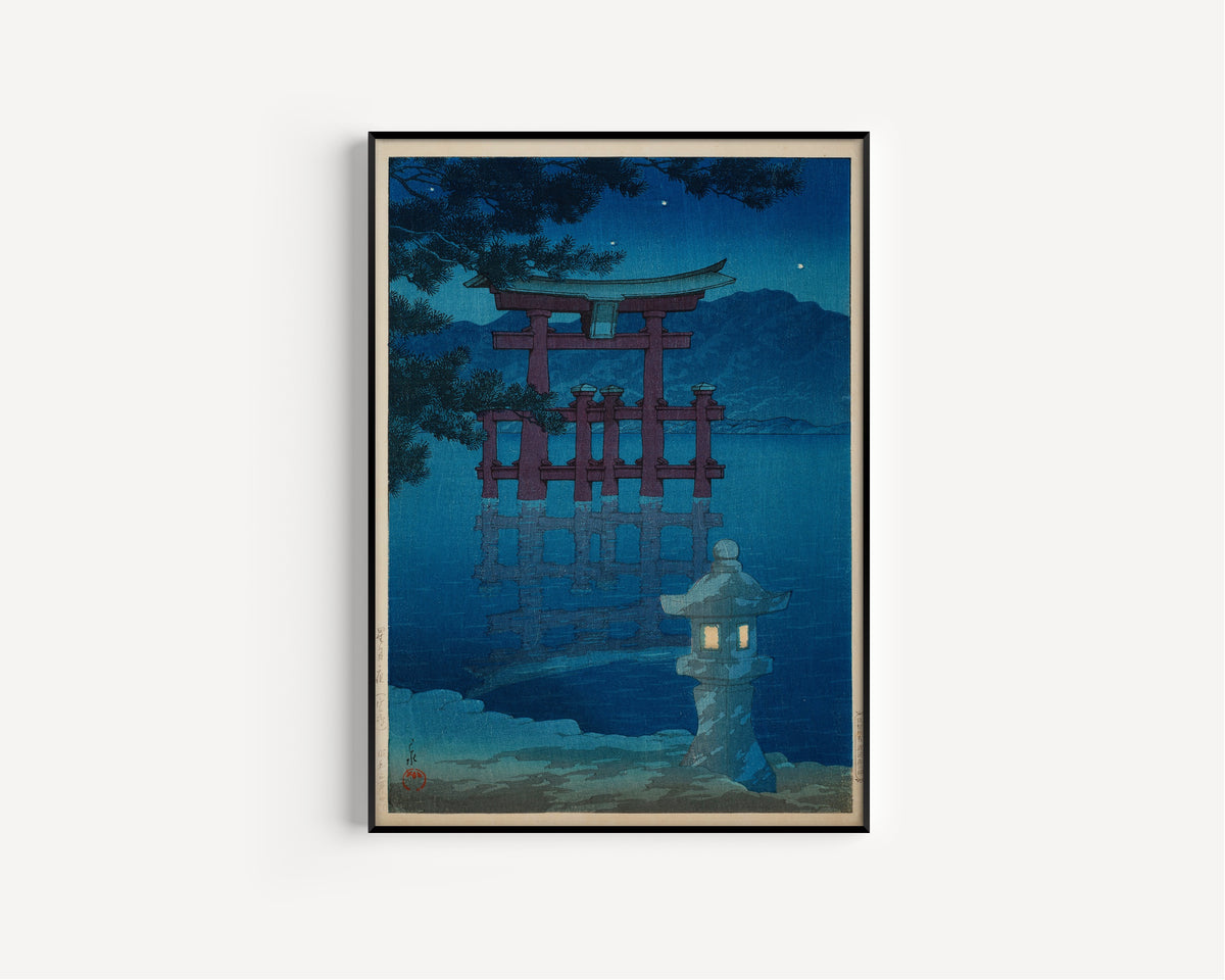 Framed art print of Starlit Night at Miyajima by Kawase Hasui, in a slim black frame on a plain white wall