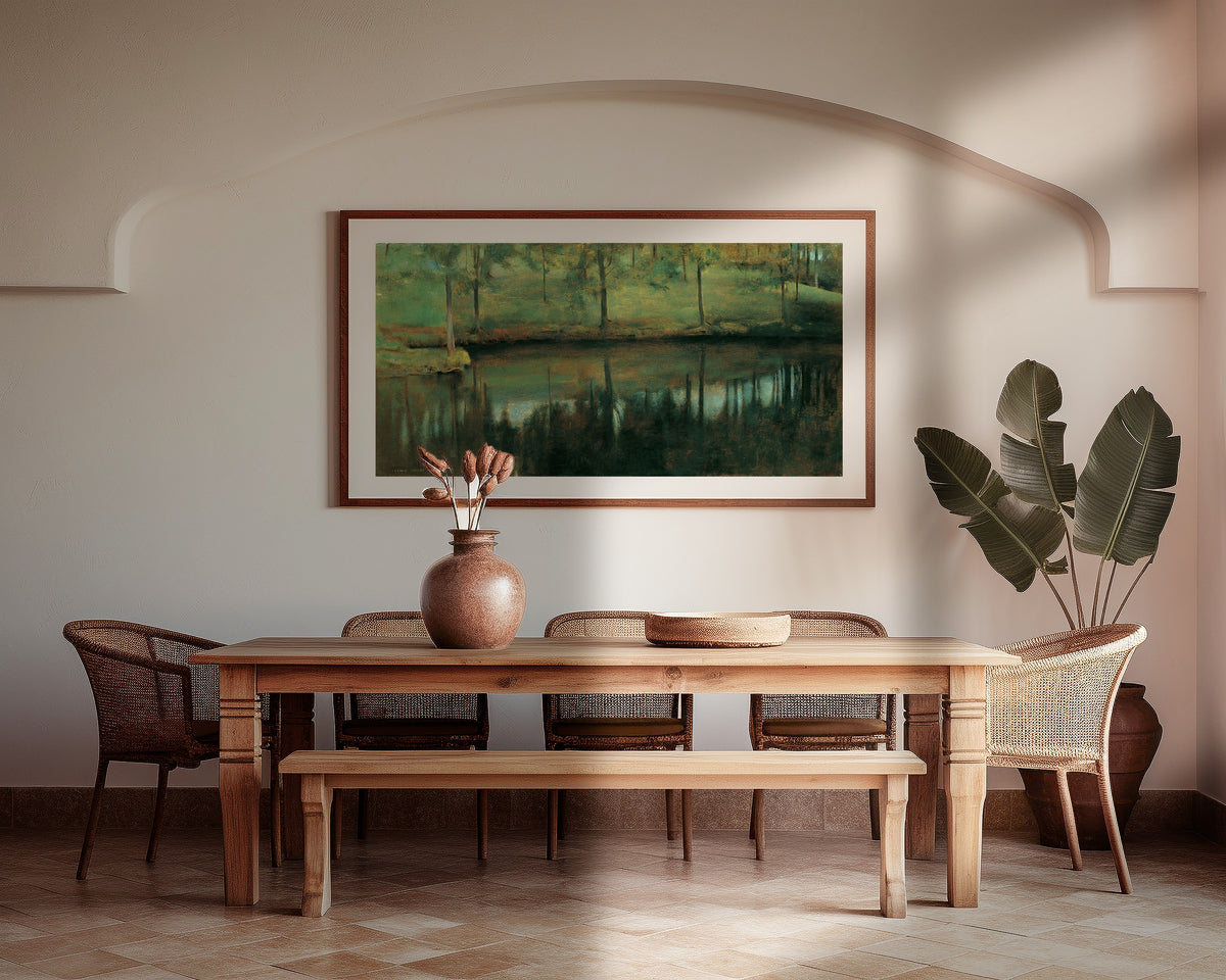 Framed art print of Still Water by Fernand Khnopff, above a wooden dining table