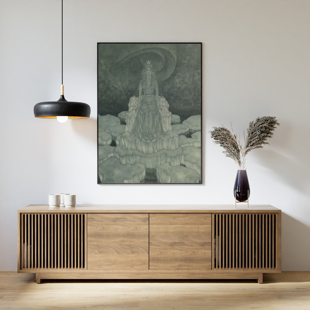 Framed art print of Stories from Hans Andersen: The Snow Queen Sat in the Very Middle of It by Edmund Dulac, above a slatted wood sideboard