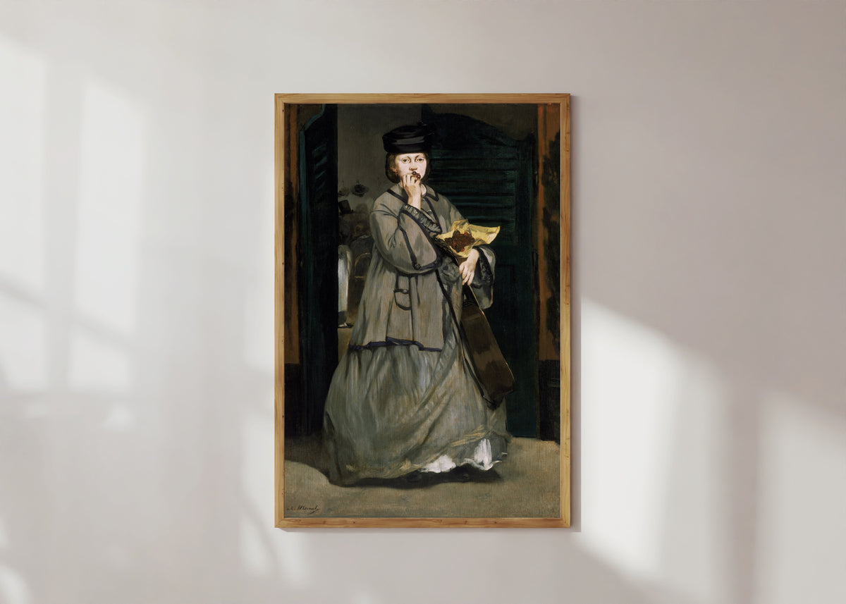 Framed art print of Street Singer by Édouard Manet, in a light wood frame on a sunlit white wall