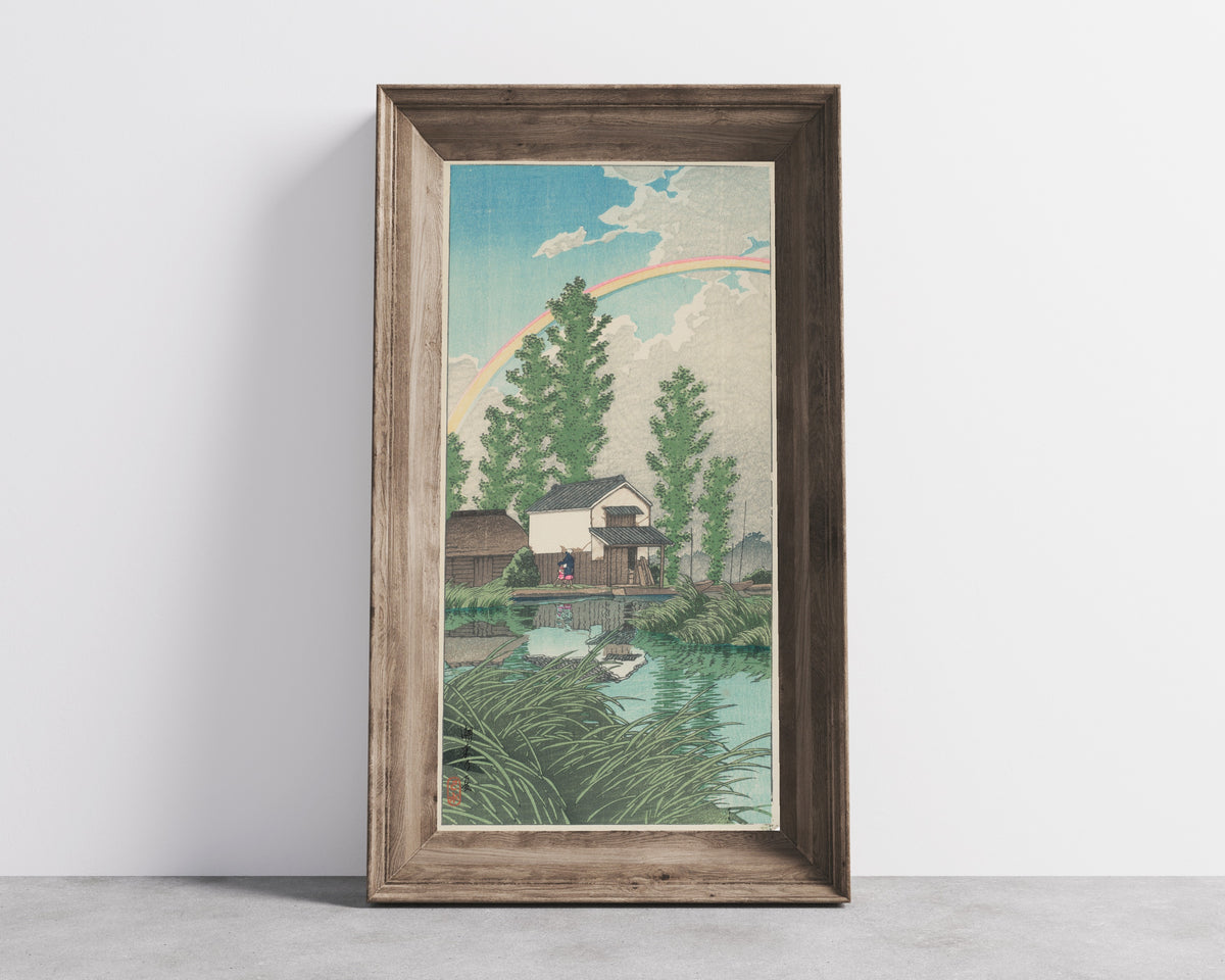 Framed art print of Summer at Itako by Kawase Hasui, in a wide wooden frame leaning against a concrete wall