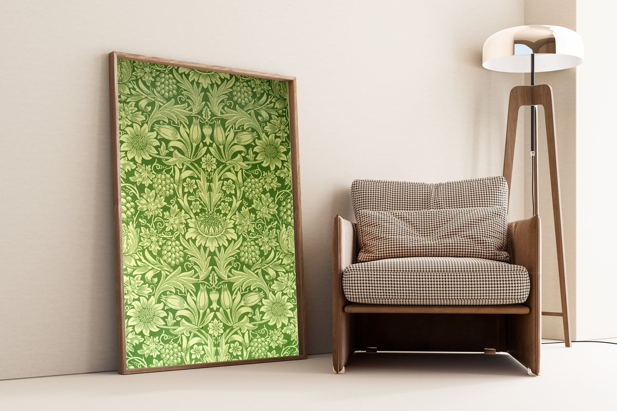 Framed art print of Sunflower by William Morris, leaning against a wall beside an armchair and a floor lamp