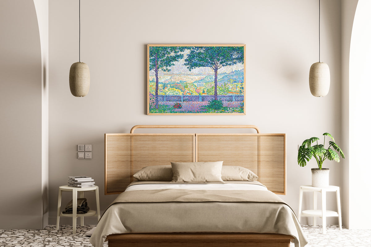 Framed art print of Terrace at Meudon by Paul Signac, above a cane-headboard bed