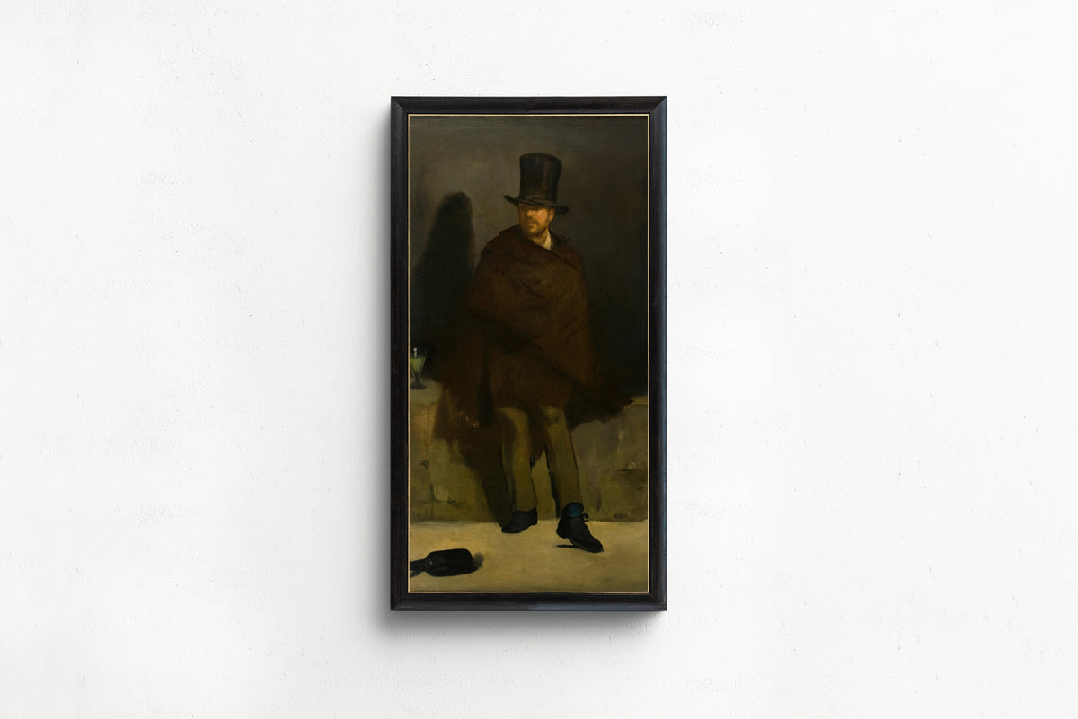 Framed art print of The Absinthe Drinker by Édouard Manet, in a slim black frame on a plain white wall