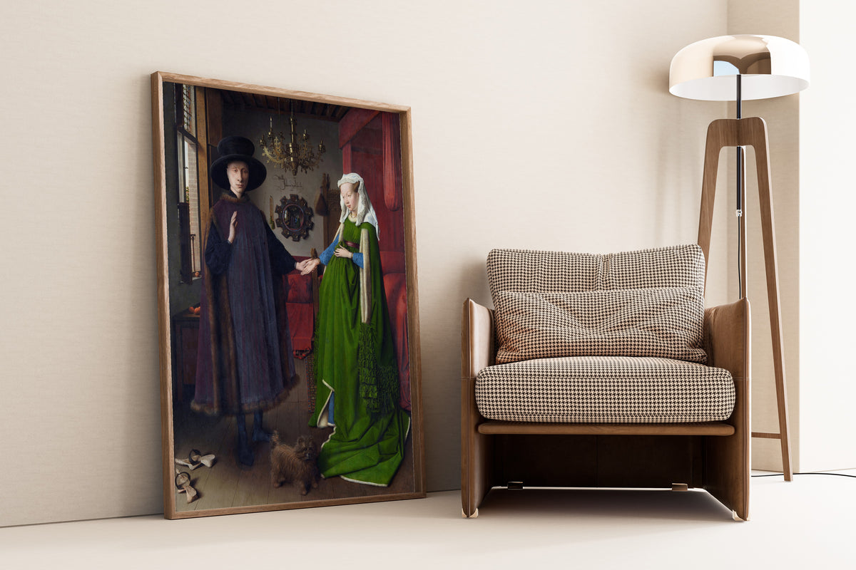 Framed art print of The Arnolfini Portrait by Jan van Eyck, leaning against a wall beside an armchair and a floor lamp