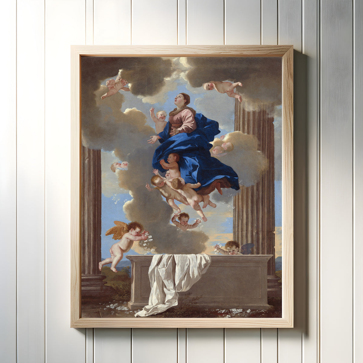 Framed art print of The Assumption of the Virgin by Nicolas Poussin, in a light wood frame on a white panelled wall