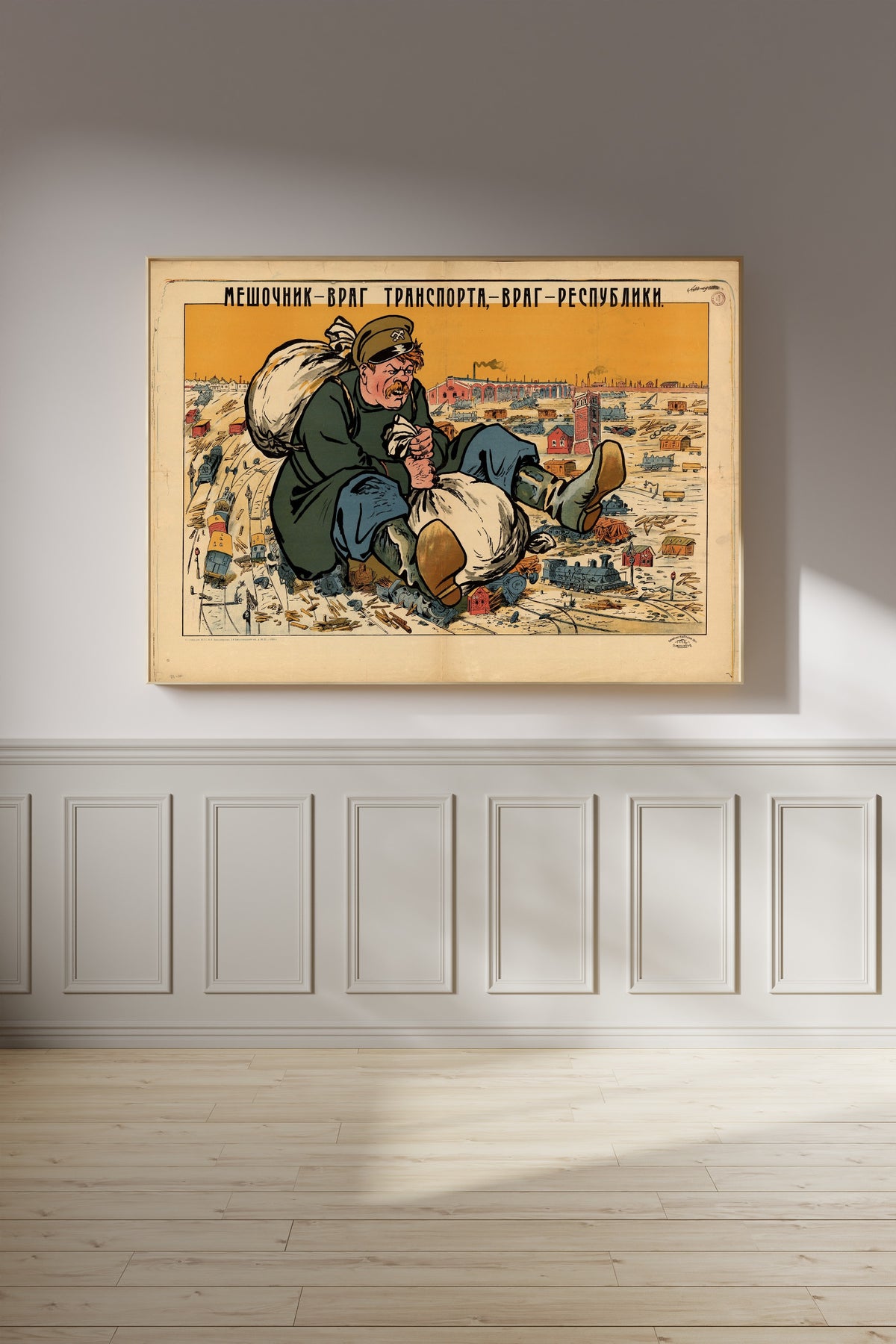 Framed art print of The Bagman Is the Enemy of Transport, the Enemy of the Republic, on a panelled wall in afternoon light