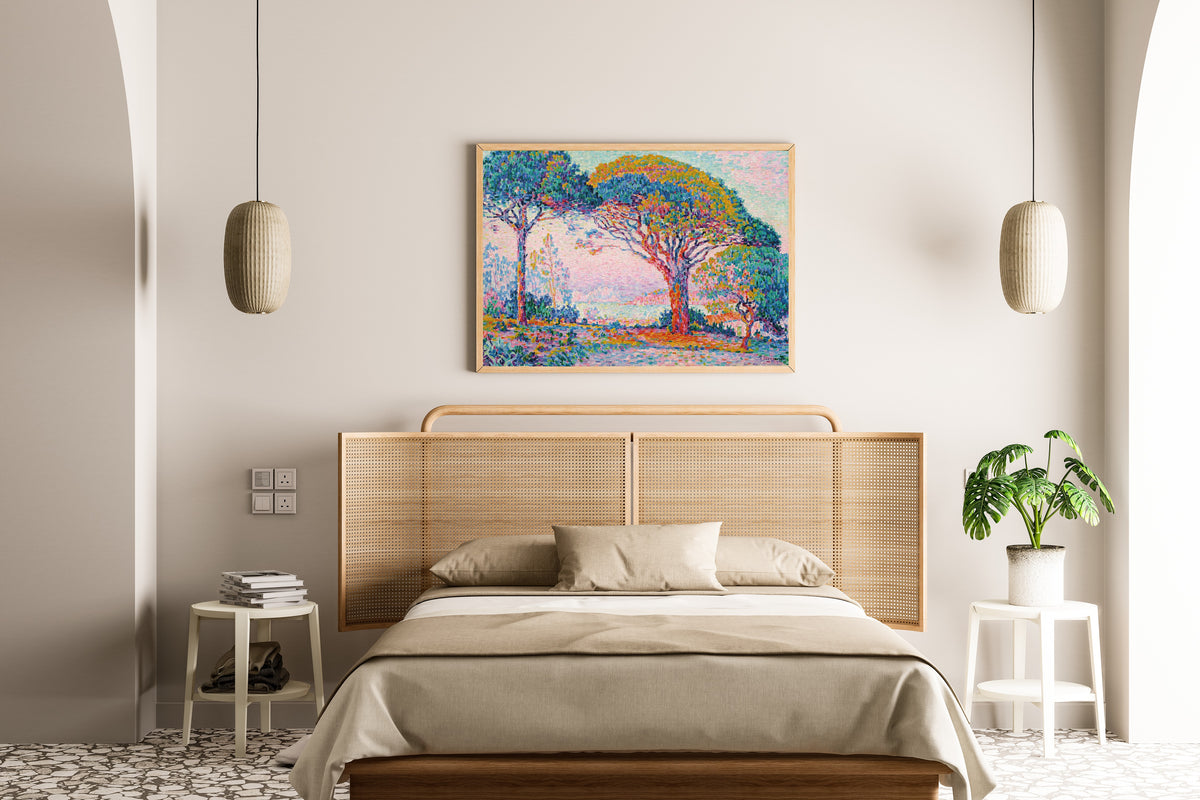 Framed art print of The Bay, Saint-Tropez by Paul Signac, above a cane-headboard bed