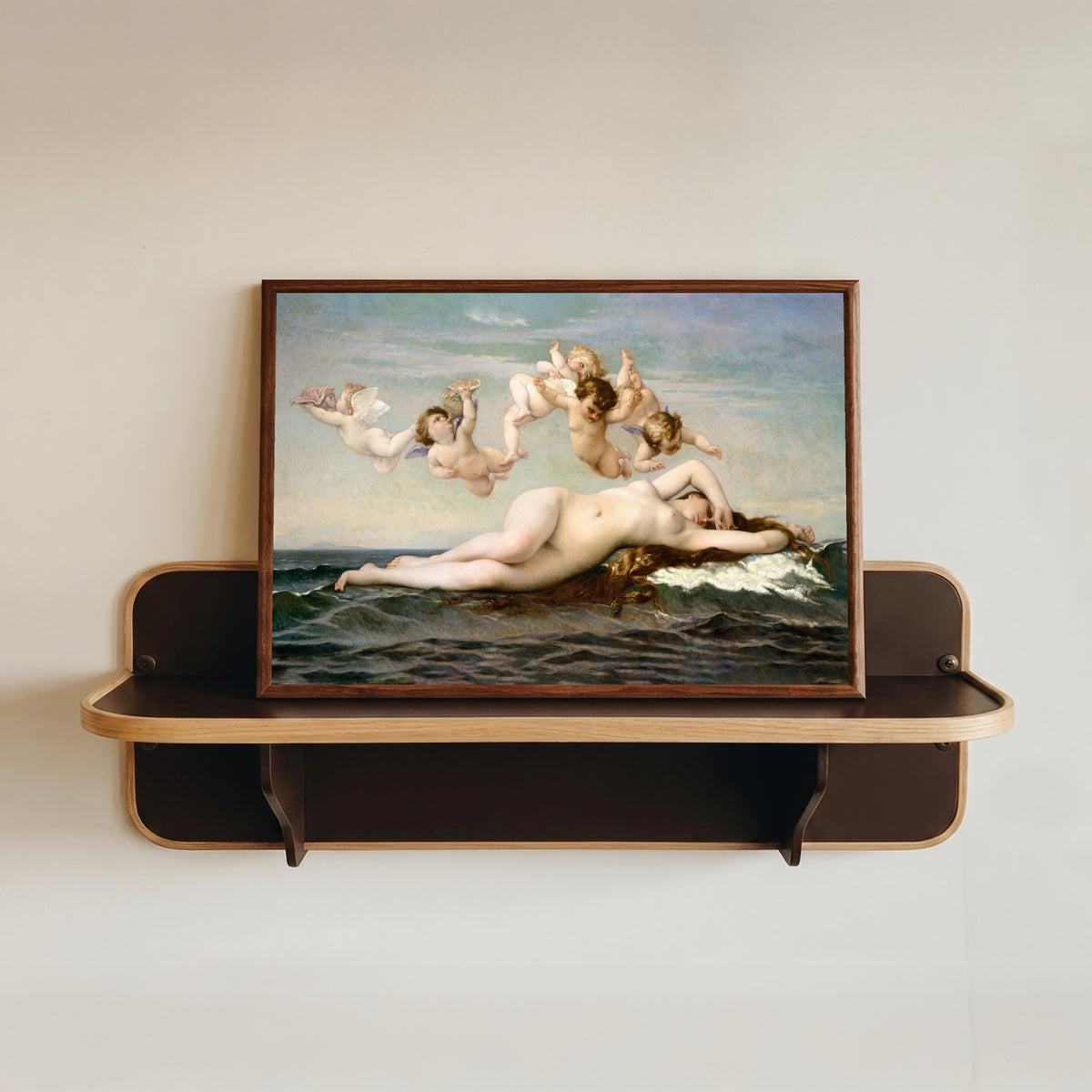 Framed art print of The Birth of Venus by Alexandre Cabanel, in a dark wood frame resting on a wall shelf