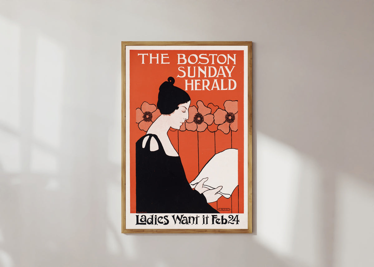 Framed art print of The Boston Sunday Herald, Ladies Want It, Feb 24 by Ethel Reed, in a light wood frame on a sunlit white wall