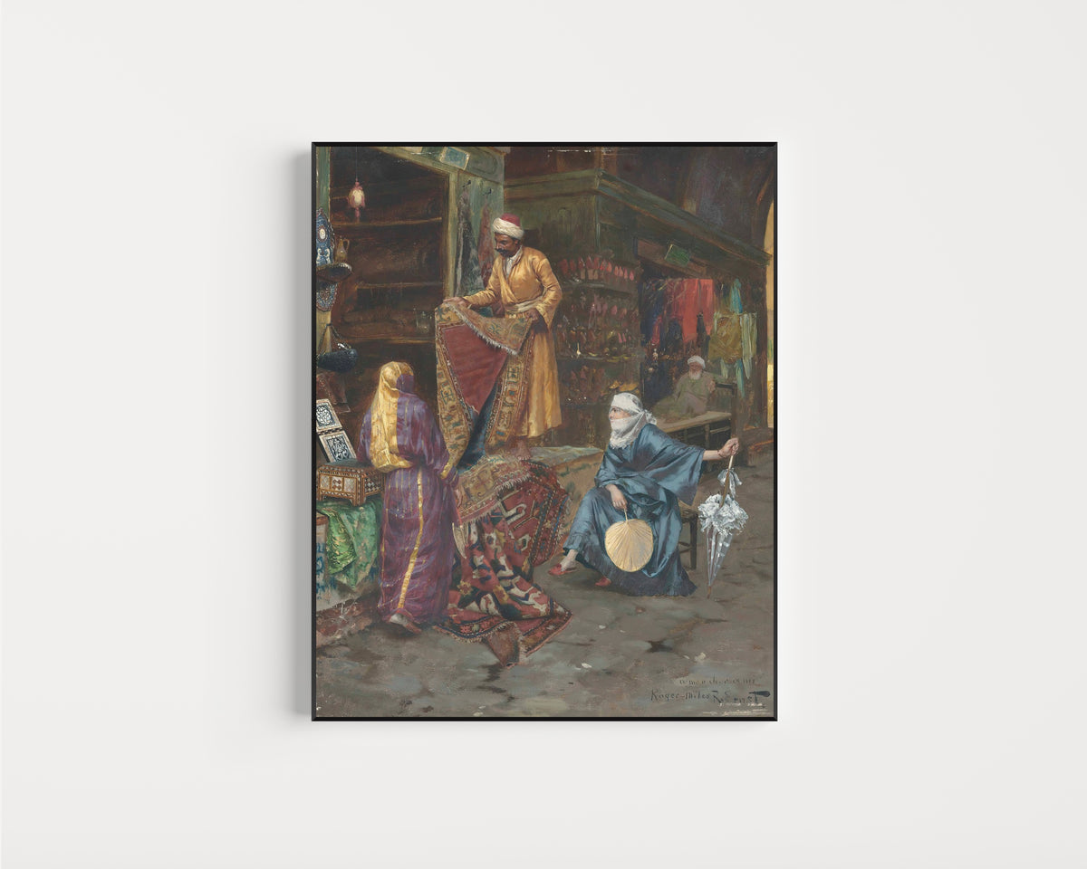 Framed art print of The Carpet Seller by Rudolf Ernst, in a slim black frame on a plain white wall