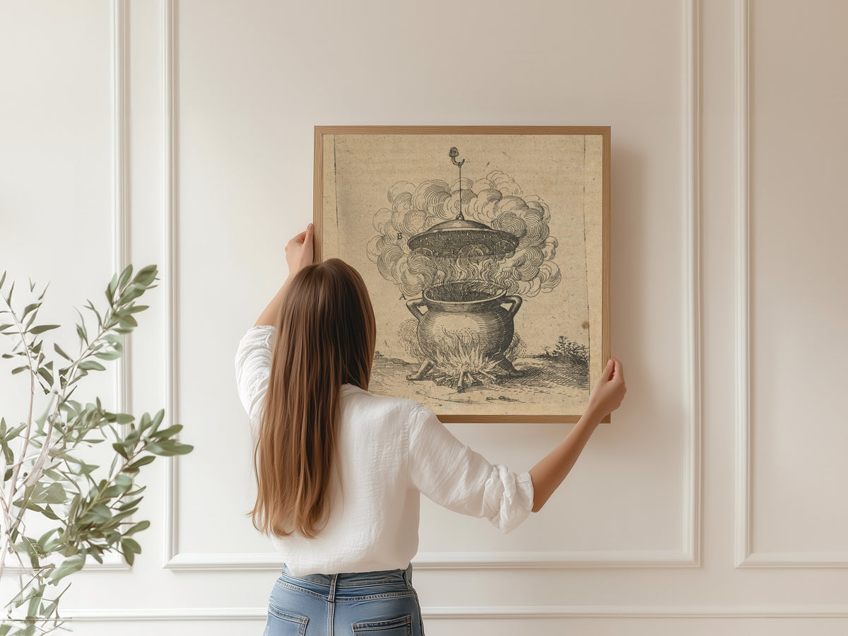 Framed art print of The Cauldron of Imperfect Mixtures over a Fire (Utriusque Cosmi, p. 201) by Robert Fludd, hung on a panelled wall