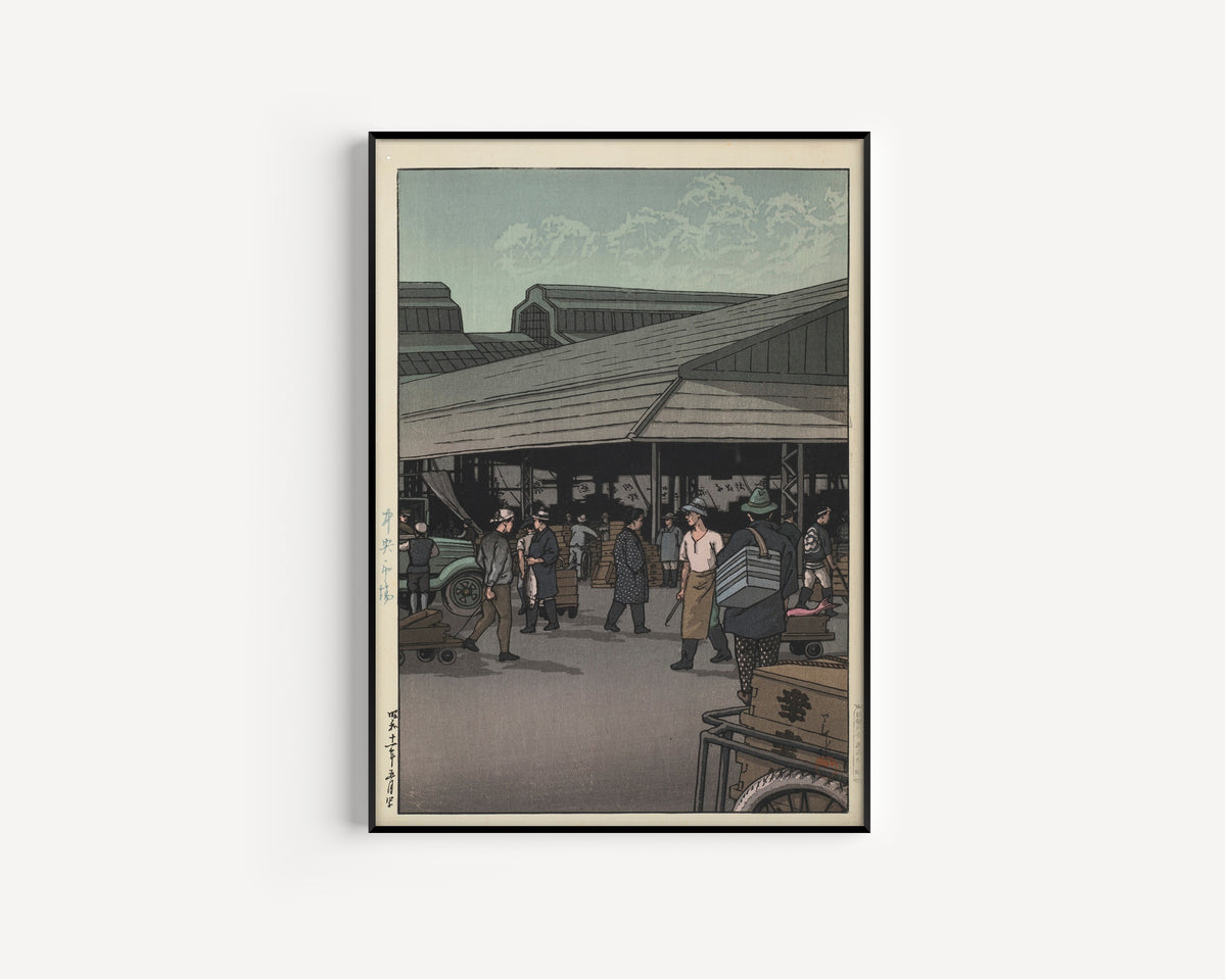 Framed art print of The Central Market by Kawase Hasui, in a slim black frame on a plain white wall