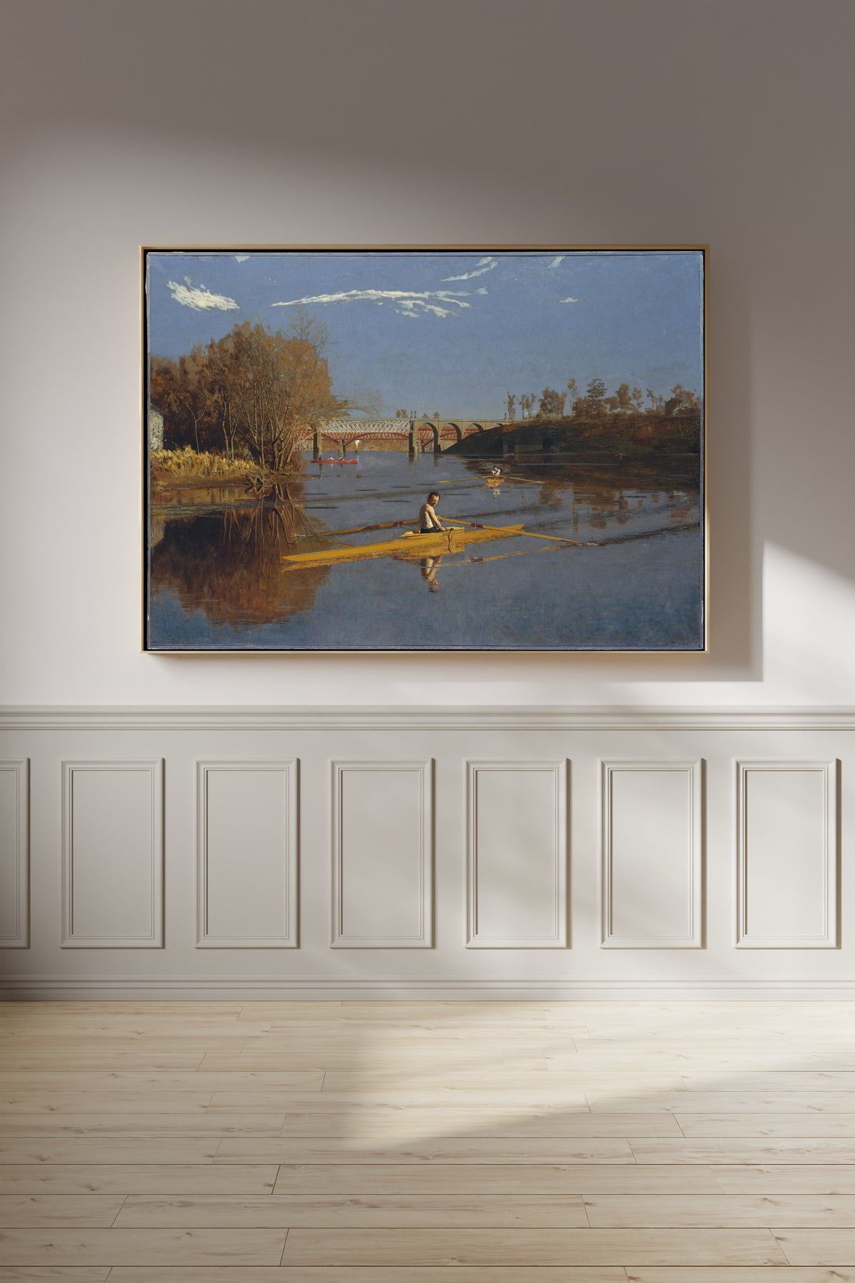 The Champion Single Sculls (Max Schmitt in a Single Scull) by Thomas Eakins — framed on a panelled wall in afternoon light