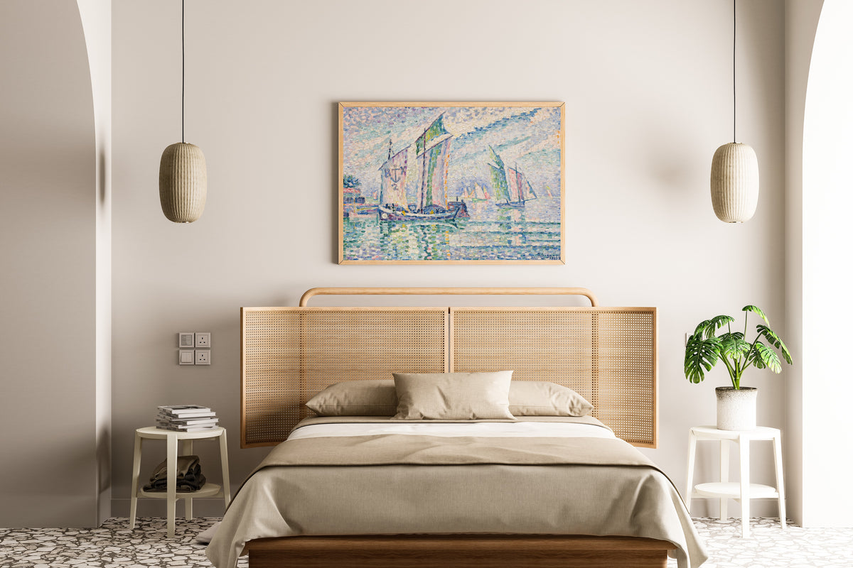 Framed art print of The Channel at La Rochelle by Paul Signac, above a cane-headboard bed
