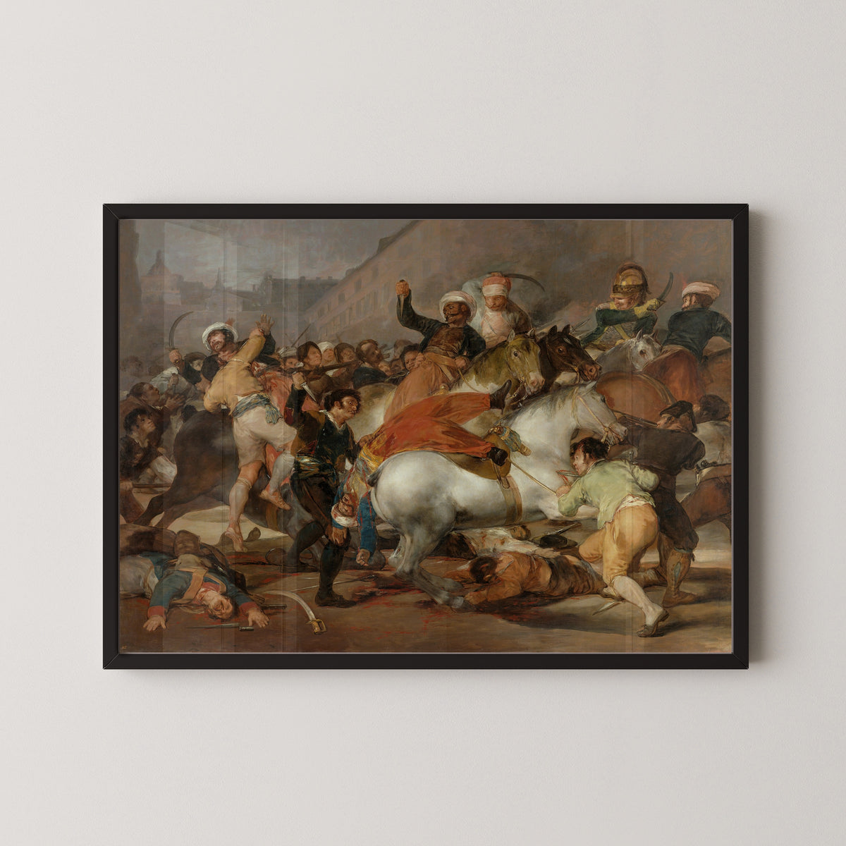 Framed art print of The Charge of the Mamelukes by Francisco de Goya, in a black frame on a pale wall