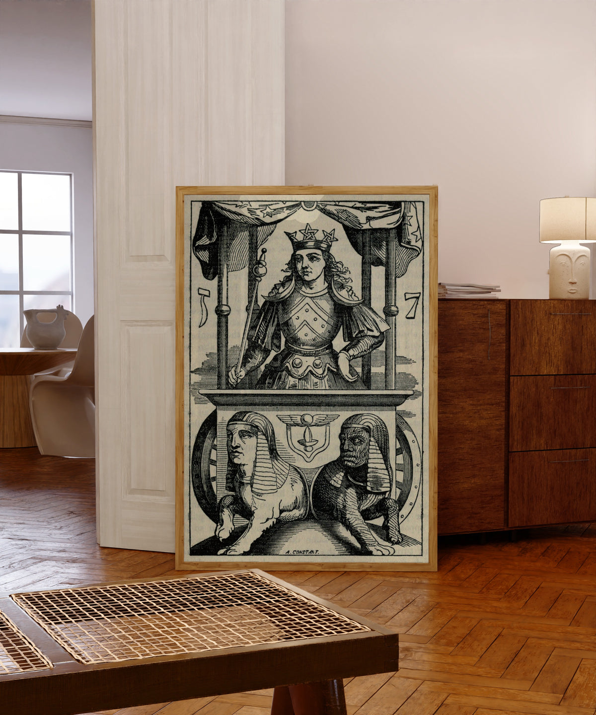 Framed art print of The Chariot of Hermes by Éliphas Lévi, in a light wood frame leaning in a warm room with a parquet floor
