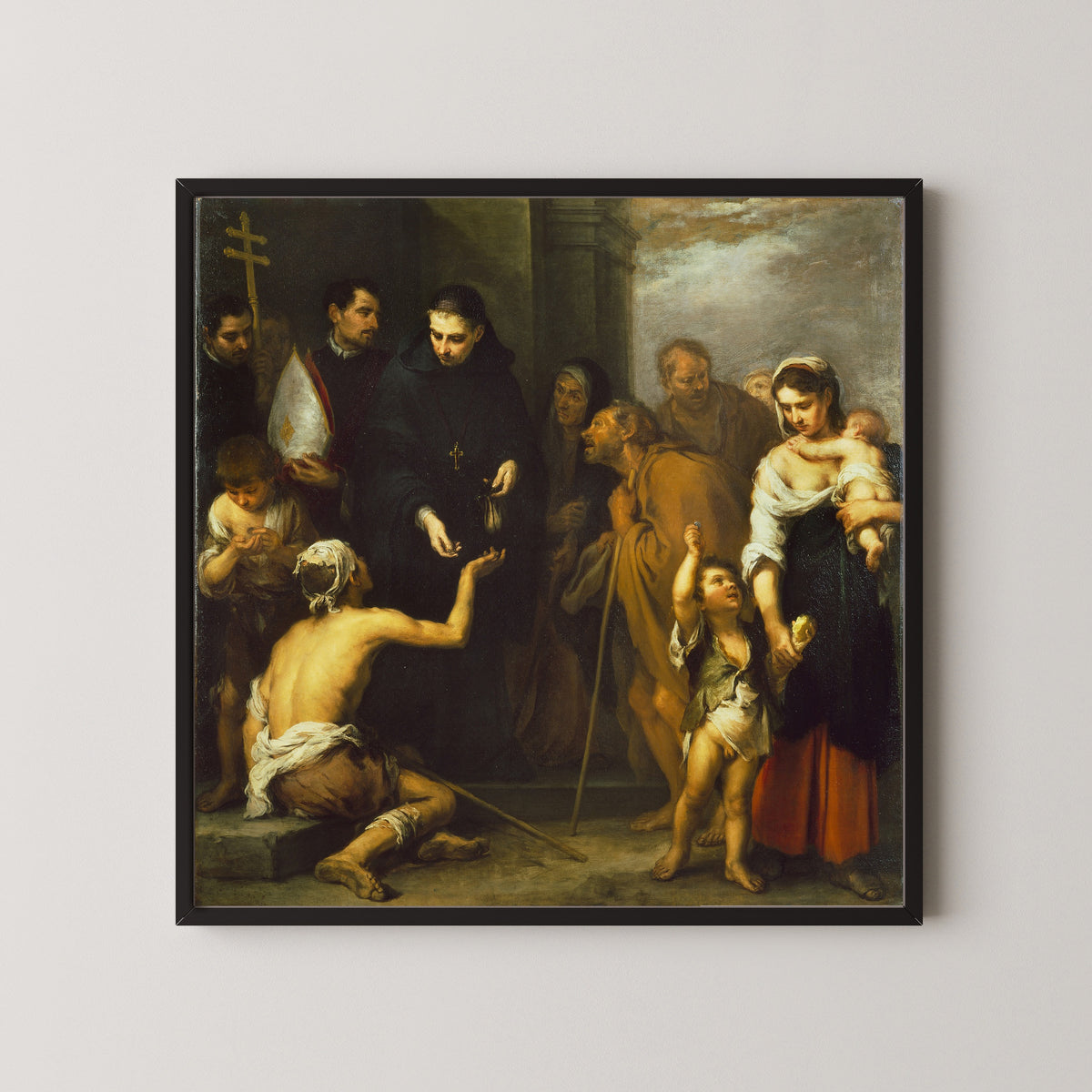 Framed art print of The Charity of Saint Thomas of Villanueva by Bartolomé Esteban Murillo, in a black frame on a pale wall
