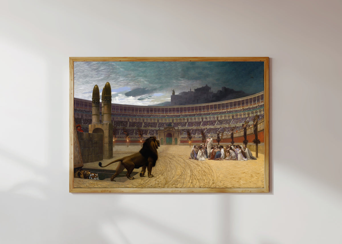 Framed art print of The Christian Martyrs' Last Prayer by Jean-Léon Gérôme, in a light wood frame on a sunlit white wall