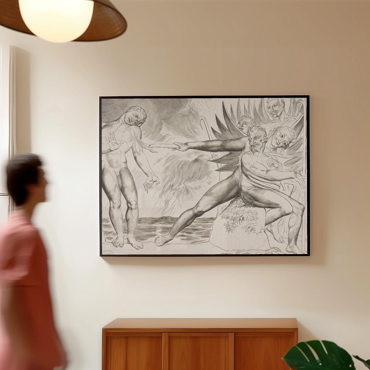 Framed art print of The Circle of Corrupt Officials: The Devils Tormenting Ciampolo by William Blake, in a slim black frame on a warm wall in a sunlit room
