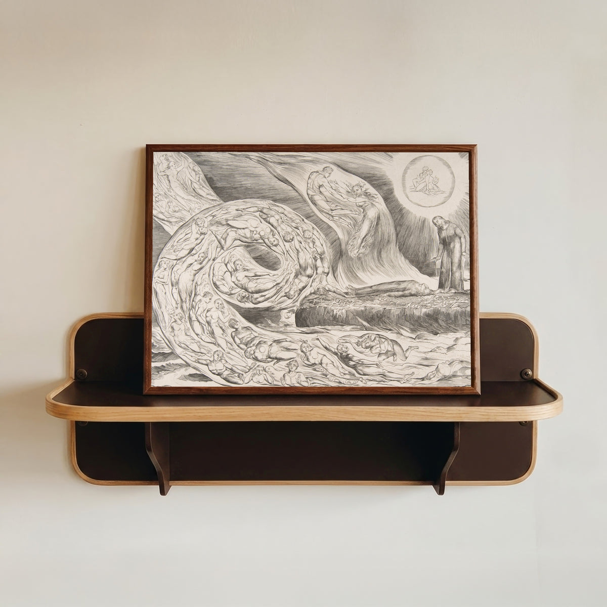 Framed art print of The Circle of the Lustful: Paolo and Francesca by William Blake, in a dark wood frame resting on a wall shelf