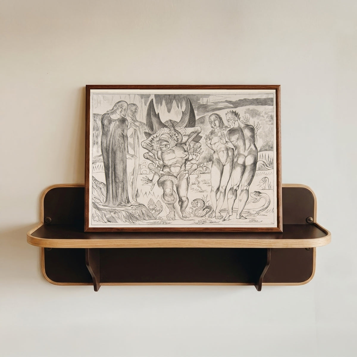 Framed art print of The Circle of the Thieves: Agnello Brunelleschi Attacked by a Six-Footed… by William Blake, in a dark wood frame resting on a wall shelf