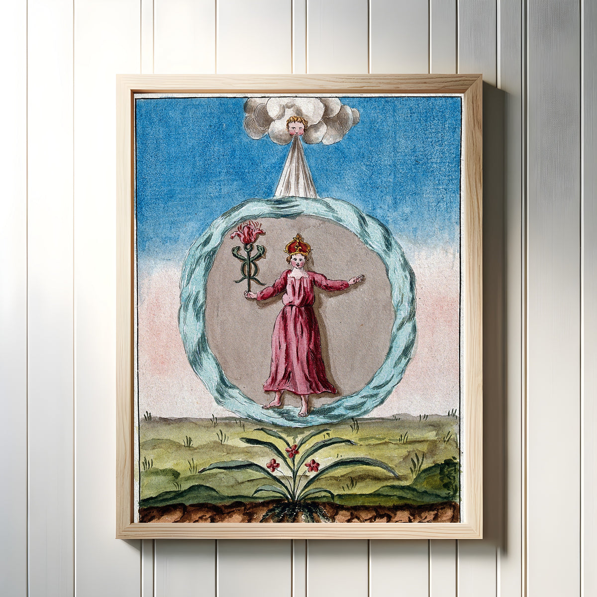 Framed art print of The Crowned Woman in Red within a Circle of Water by After Nicolas Flamel, in a light wood frame on a white panelled wall