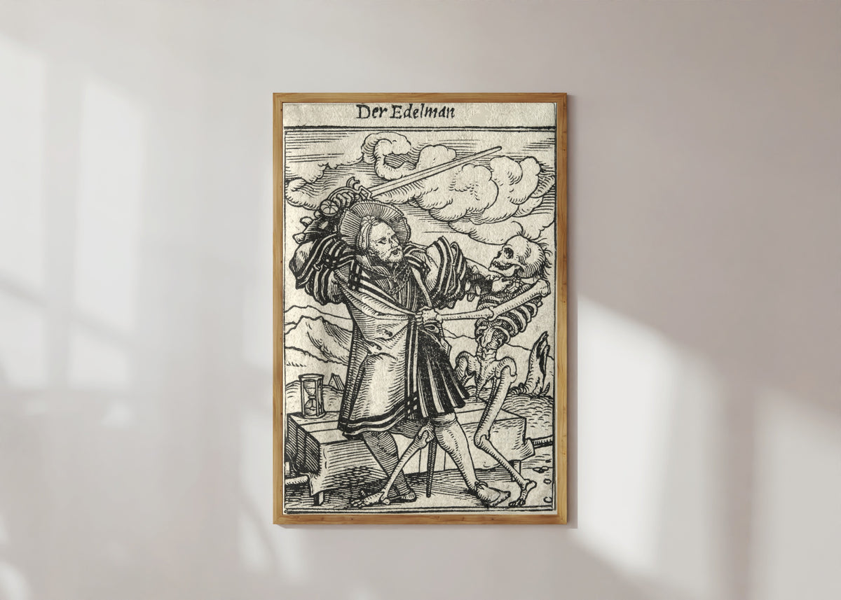 Framed art print of The Dance of Death: Der Edelman (The Nobleman) by Hans Holbein the Younger, in a light wood frame on a sunlit white wall