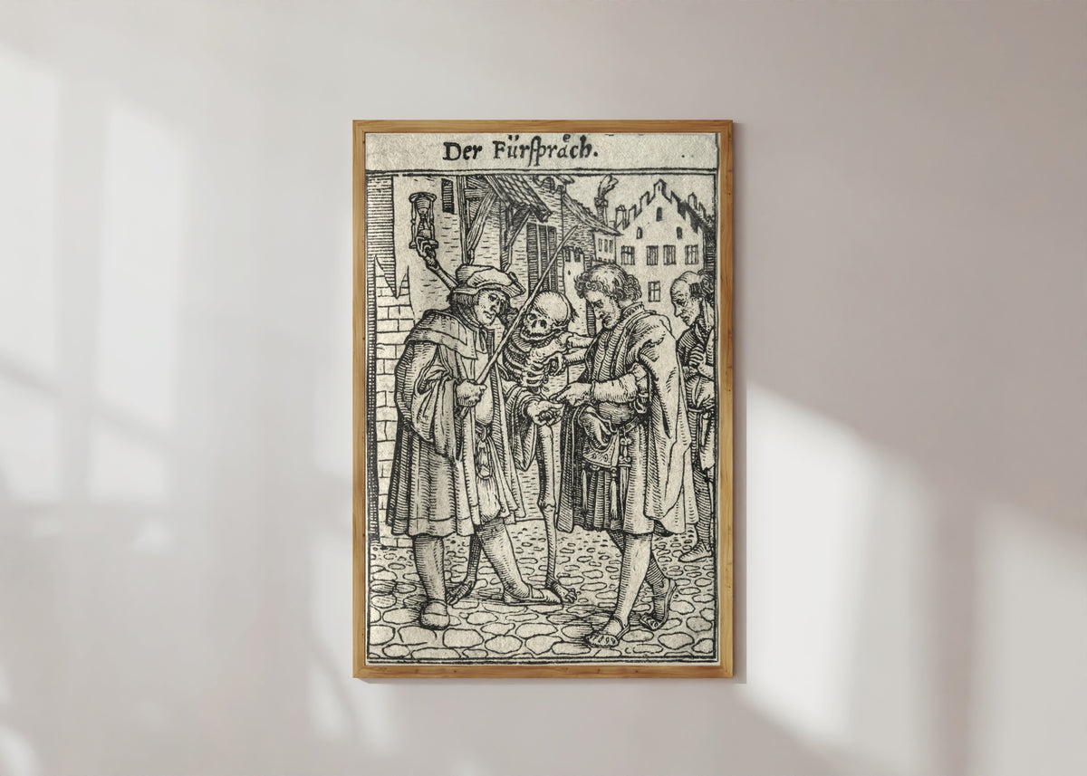 Framed art print of The Dance of Death: Der Fürspräch (The Advocate) by Hans Holbein the Younger, in a light wood frame on a sunlit white wall
