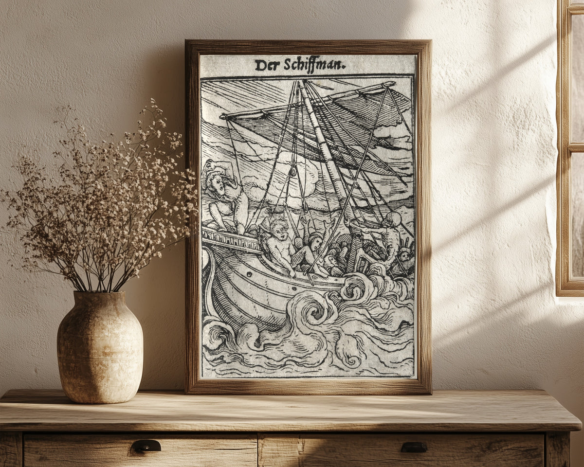 Framed art print of The Dance of Death: Der Schiffman (The… by Hans Holbein the Younger, in a dark wood frame leaning on a rustic console beside dried flowers