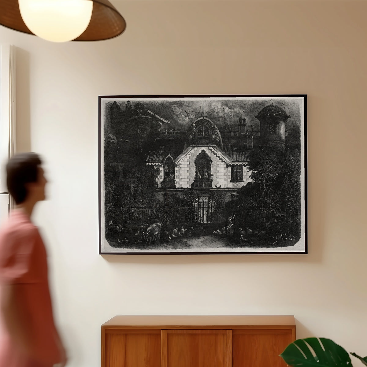 Framed art print of The Enchanted House by Rodolphe Bresdin, in a slim black frame on a warm wall in a sunlit room