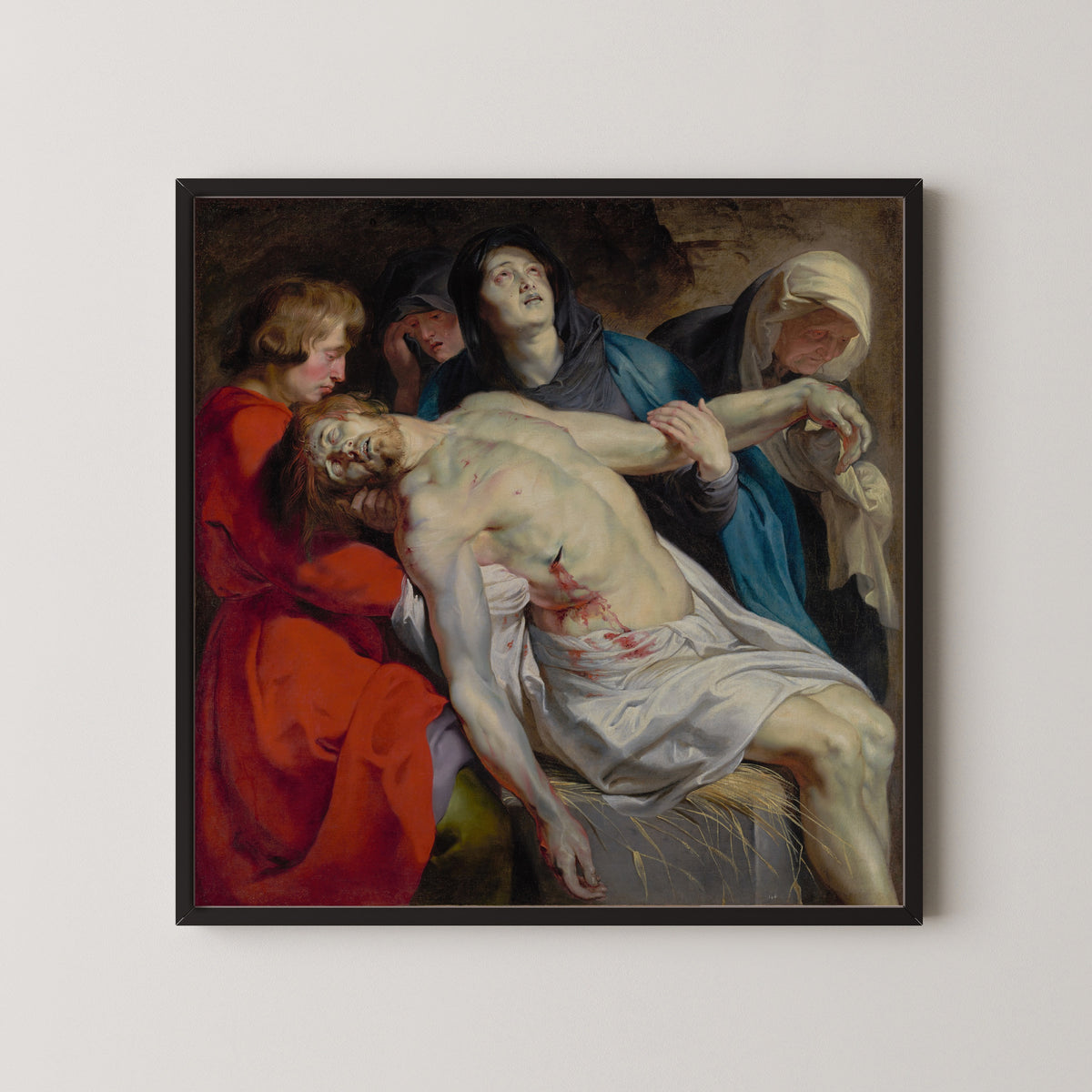 Framed art print of The Entombment by Peter Paul Rubens, in a black frame on a pale wall