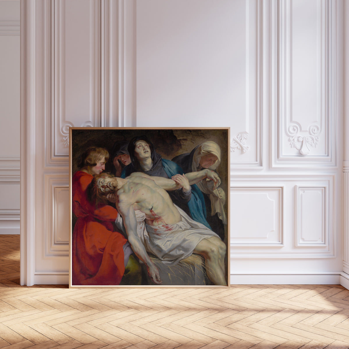 Framed art print of The Entombment by Peter Paul Rubens, leaning against pale pink panelling on a herringbone floor
