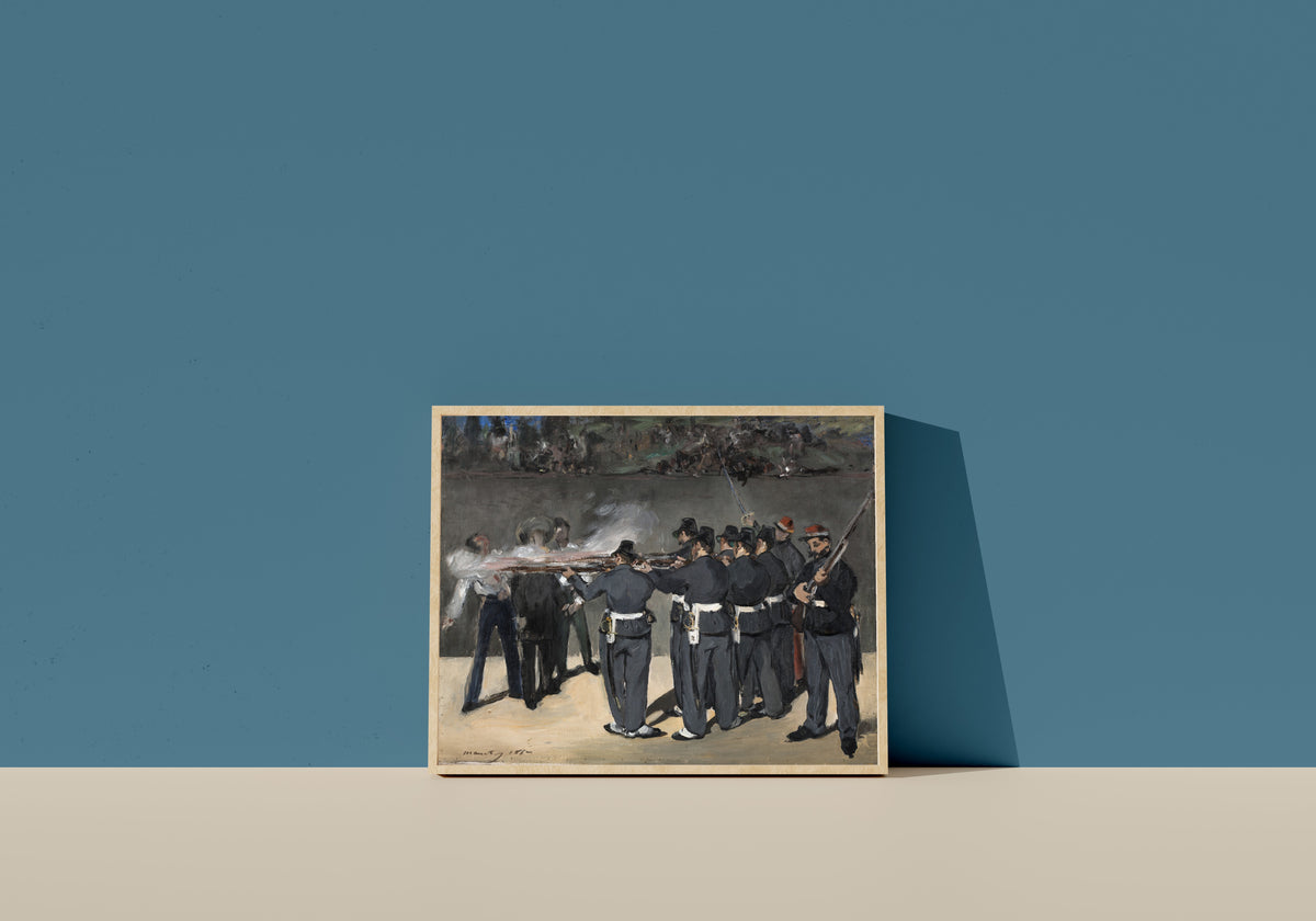 Framed art print of The Execution of Emperor Maximilian by Édouard Manet, in a light wood frame leaning on a blue wall