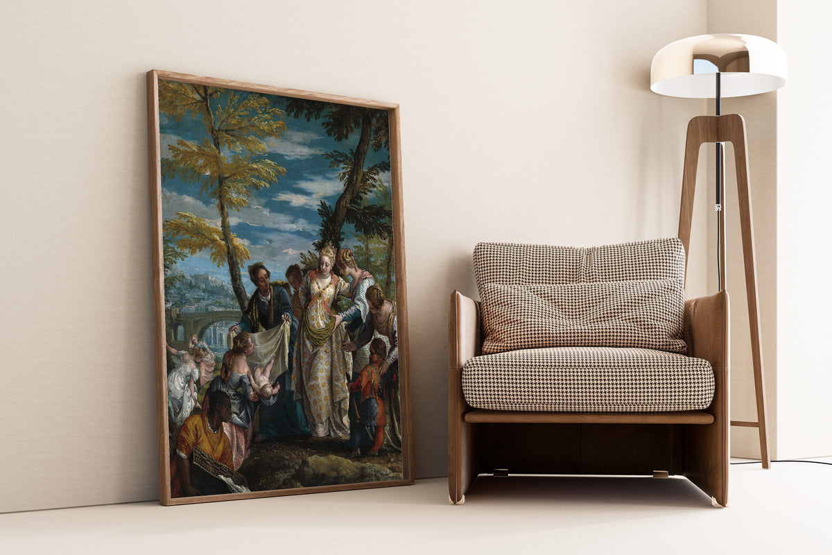 Framed art print of The Finding of Moses by Paolo Veronese, leaning against a wall beside an armchair and a floor lamp