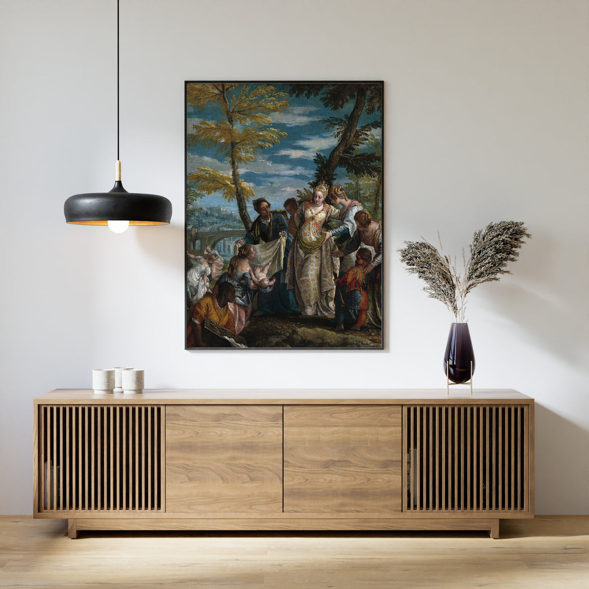 Framed art print of The Finding of Moses by Paolo Veronese, above a slatted wood sideboard