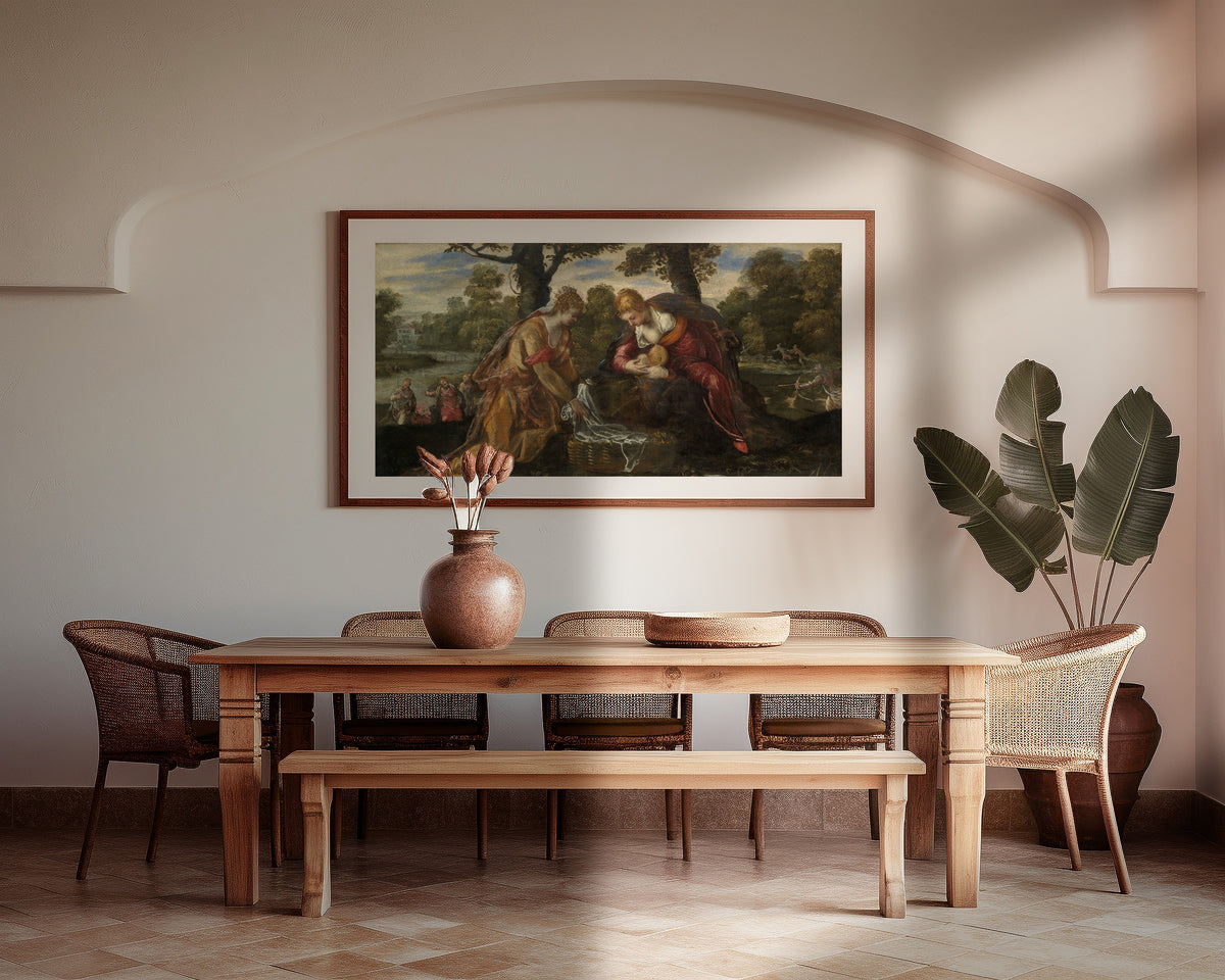 Framed art print of The Finding of Moses by Tintoretto, above a wooden dining table