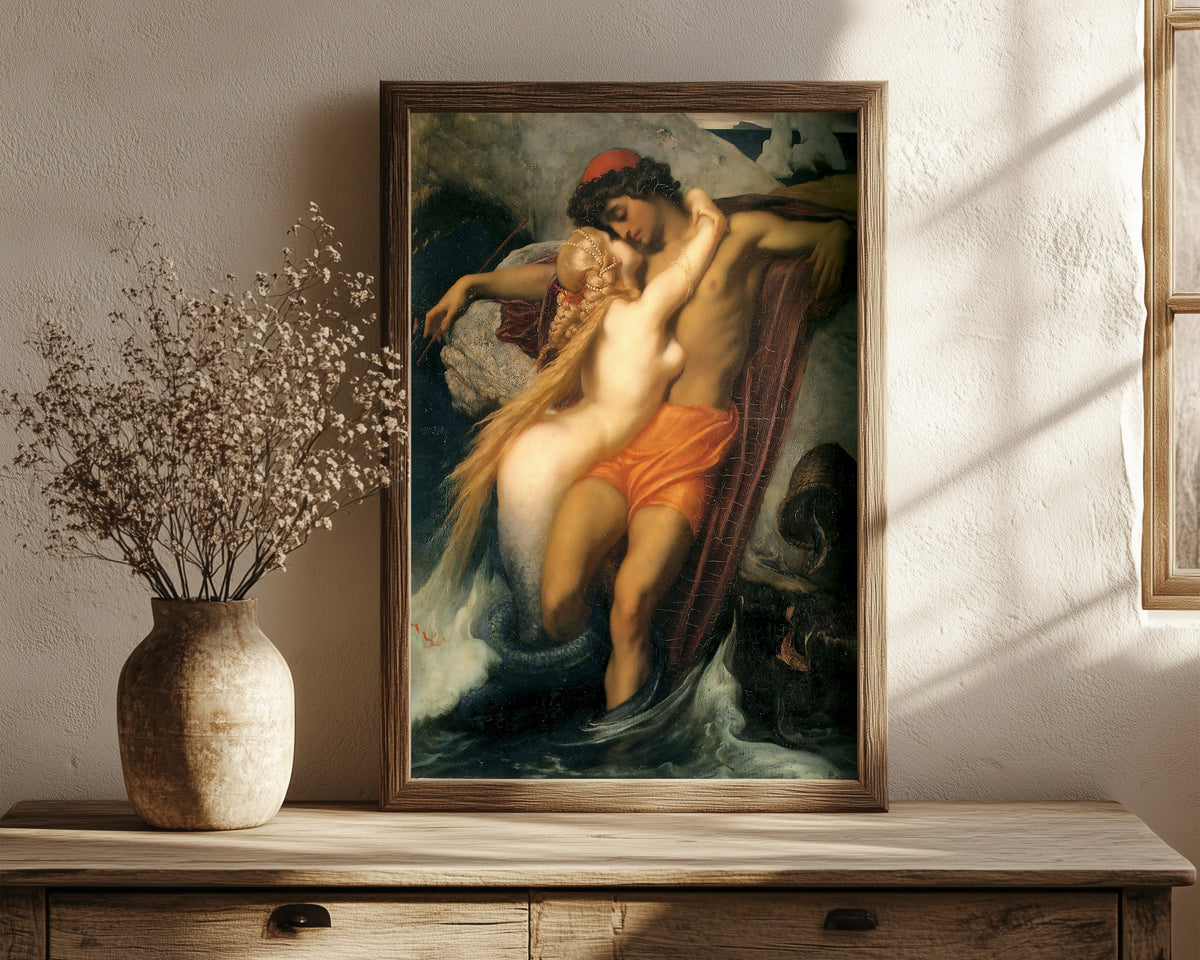 Framed art print of The Fisherman and the Syren by Frederic Leighton, in a dark wood frame leaning on a rustic console beside dried flowers
