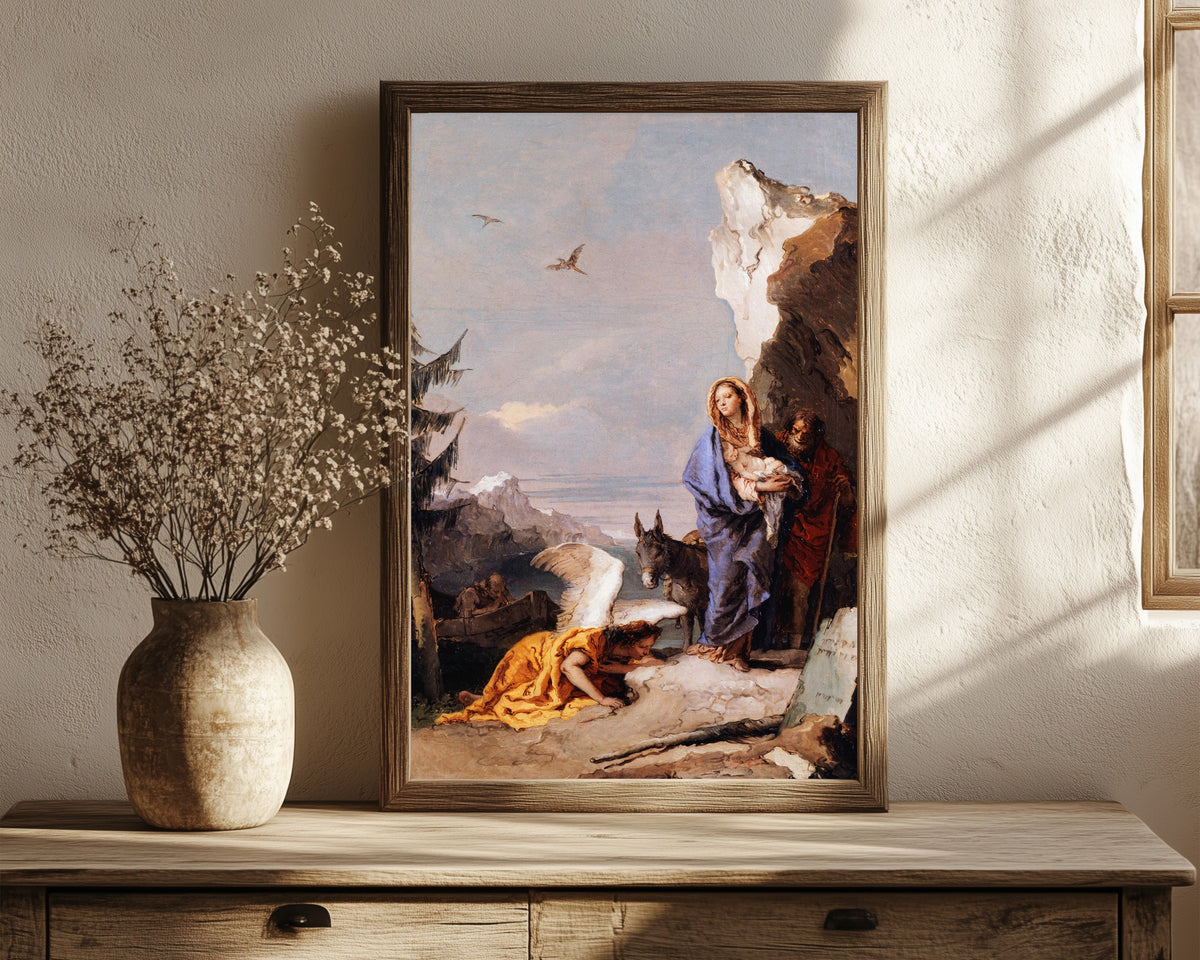 Framed art print of The Flight into Egypt by Giovanni Battista Tiepolo, in a dark wood frame leaning on a rustic console beside dried flowers