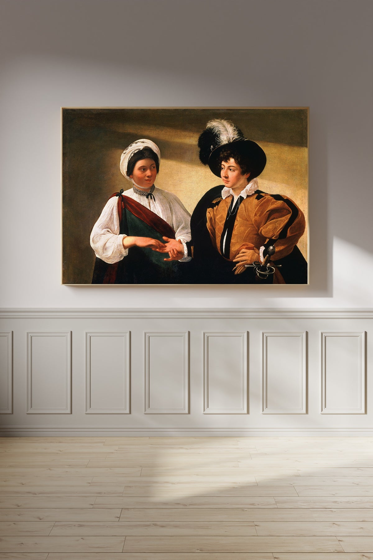 Framed art print of The Fortune Teller by Caravaggio, on a panelled wall in afternoon light