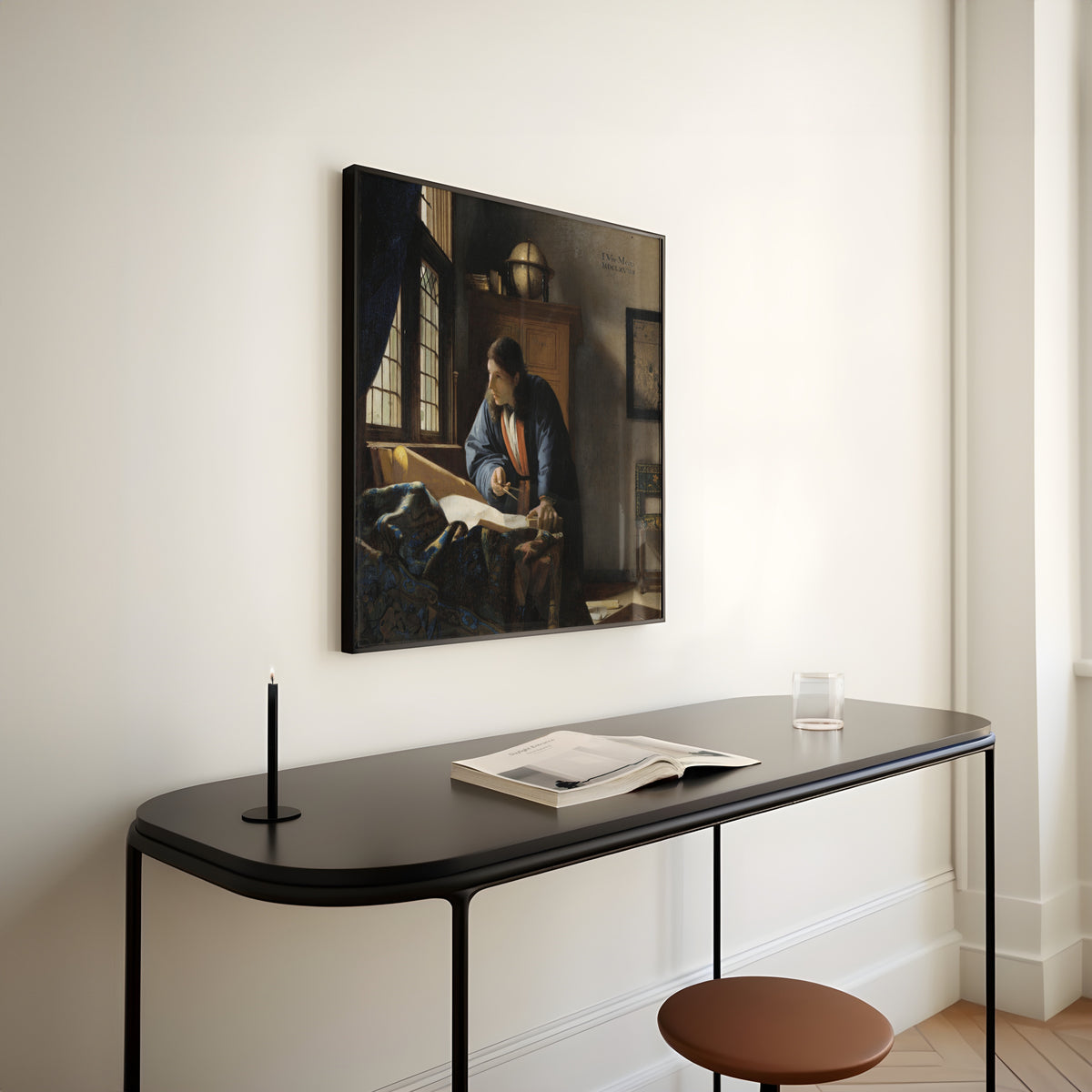 Framed art print of The Geographer by Johannes Vermeer, above a slim black console table