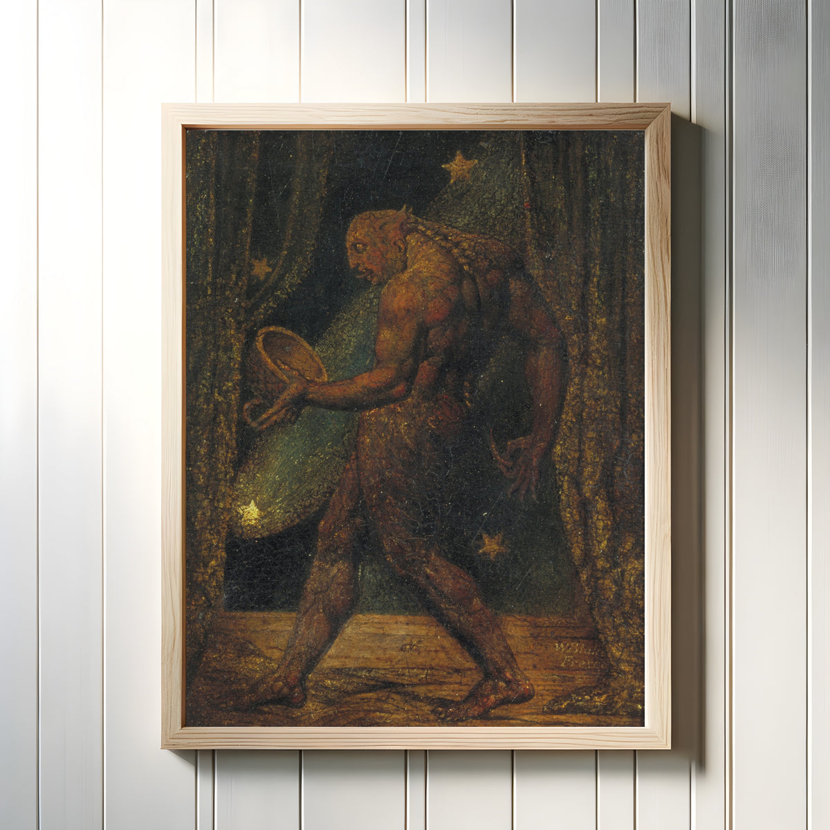 Framed art print of The Ghost of a Flea by William Blake, in a light wood frame on a white panelled wall