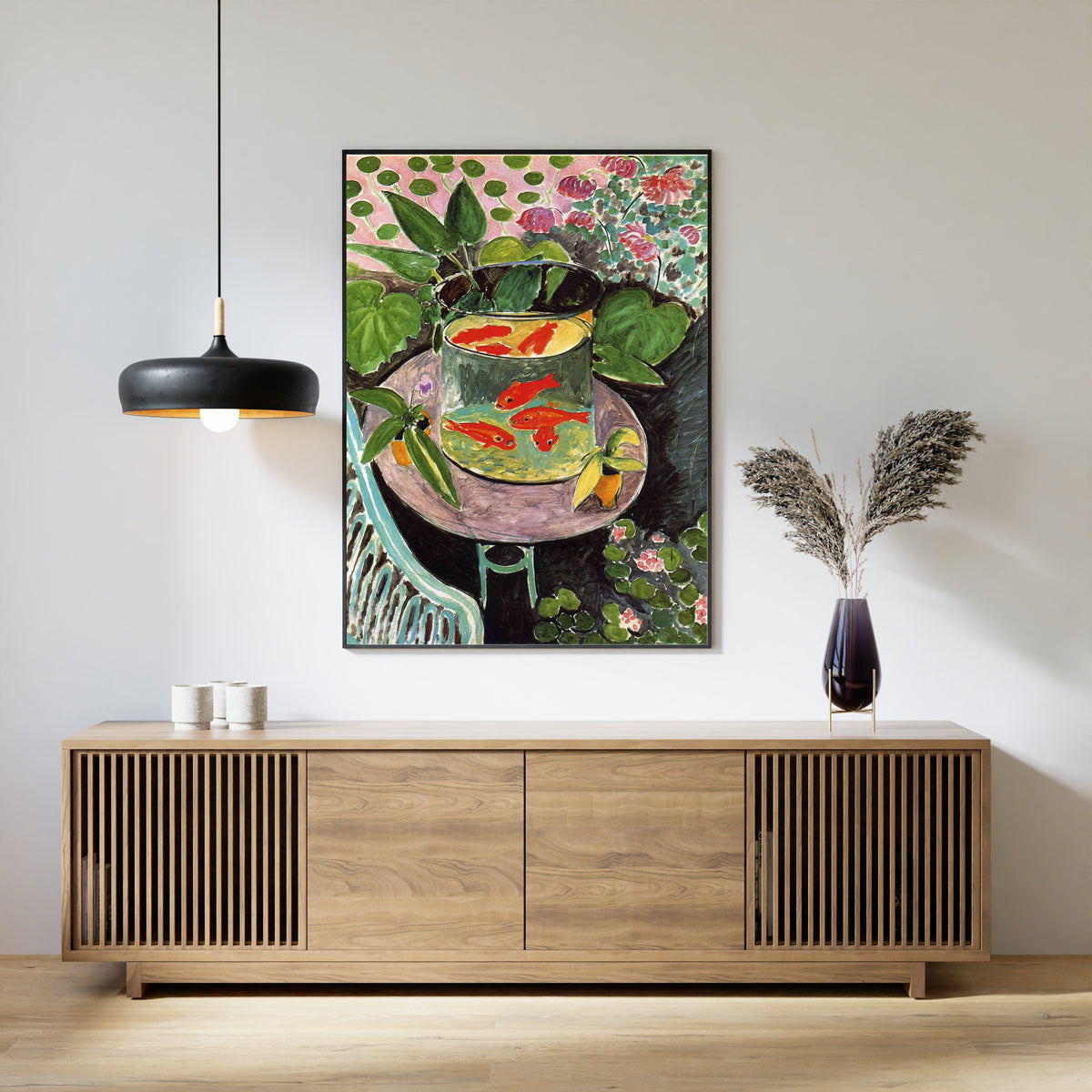 Framed art print of The Goldfish by Henri Matisse, above a slatted wood sideboard
