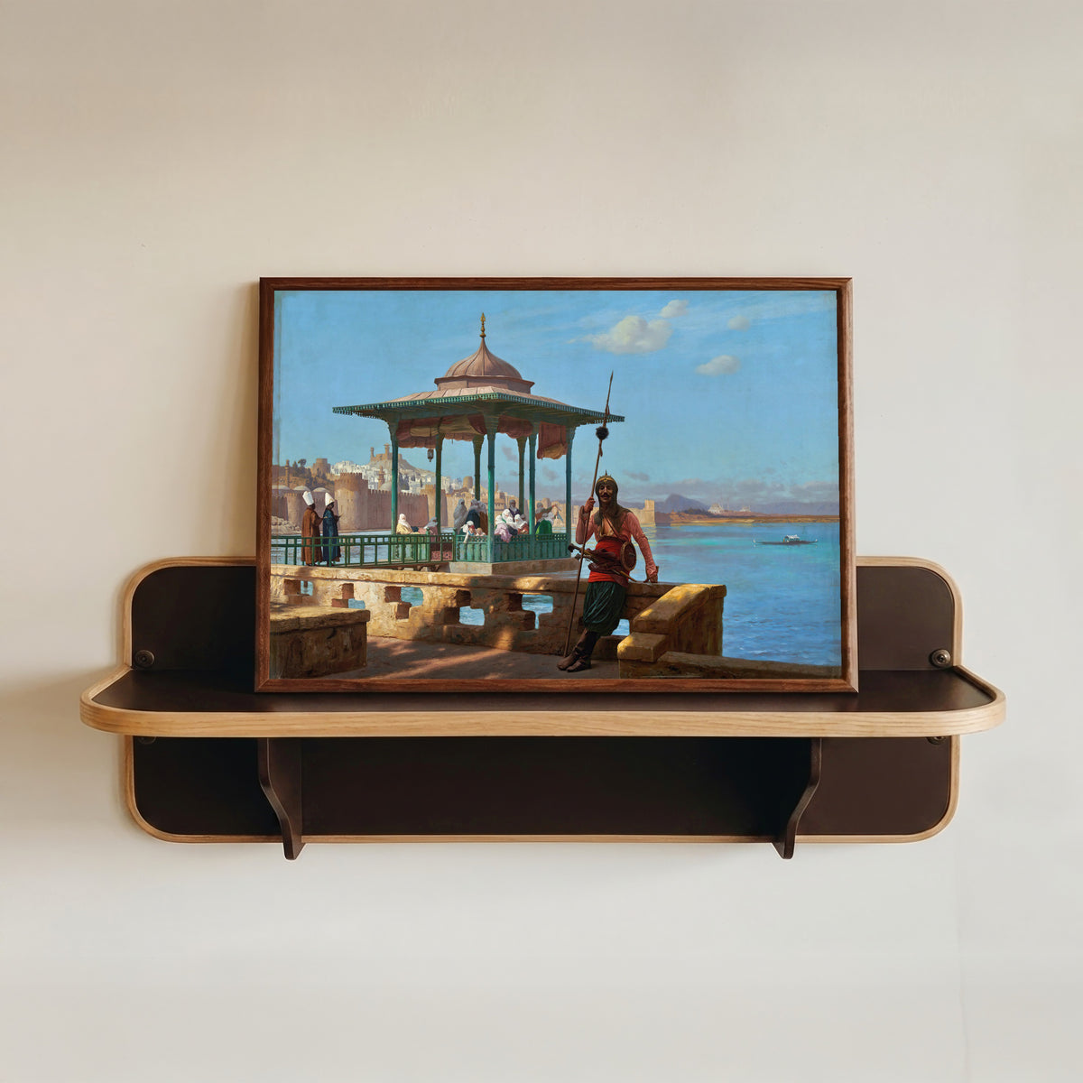 Framed art print of The Harem in the Kiosk by Jean-Léon Gérôme, in a dark wood frame resting on a wall shelf