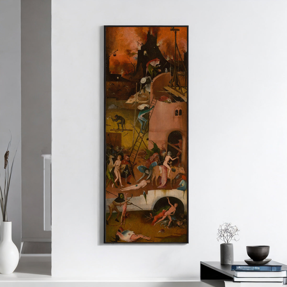 Framed art print of The Haywain Triptych - Hell (right wing) by Hieronymus Bosch, on a white wall above books and a bowl
