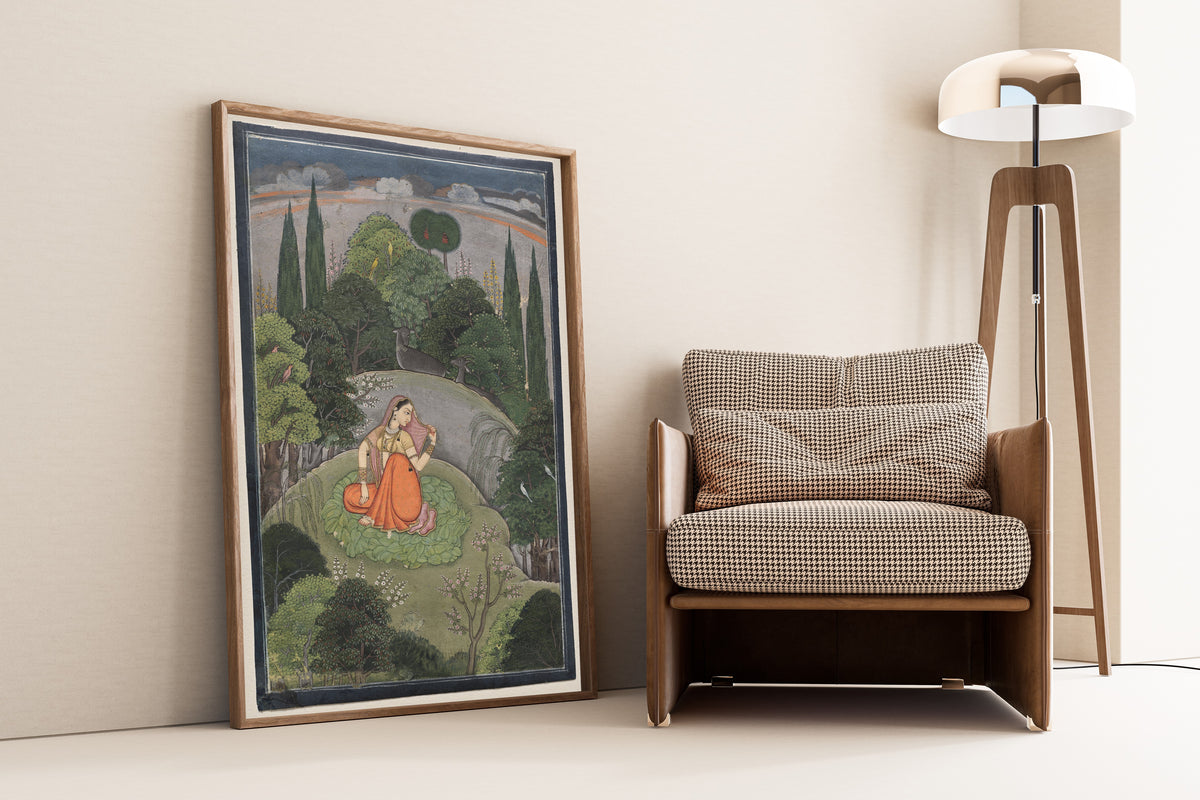 Framed art print of The Heroine Who Waits Anxiously for Her Absent Lover: Utka… by Pahari school, leaning against a wall beside an armchair and a floor lamp