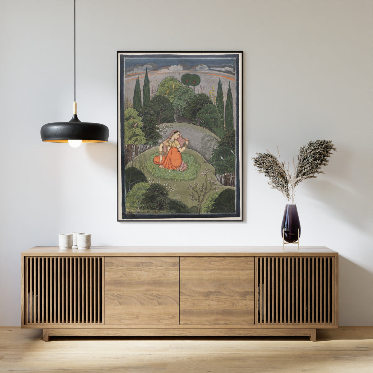 Framed art print of The Heroine Who Waits Anxiously for Her Absent Lover: Utka Nayika by Pahari school, above a slatted wood sideboard