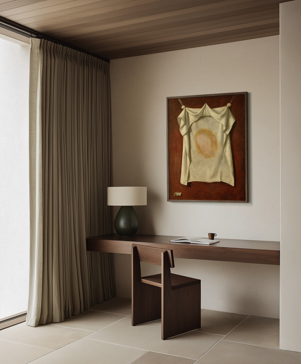 Framed art print of The Holy Face by Francisco de Zurbarán, in a dark wood frame on a plaster wall above a walnut desk