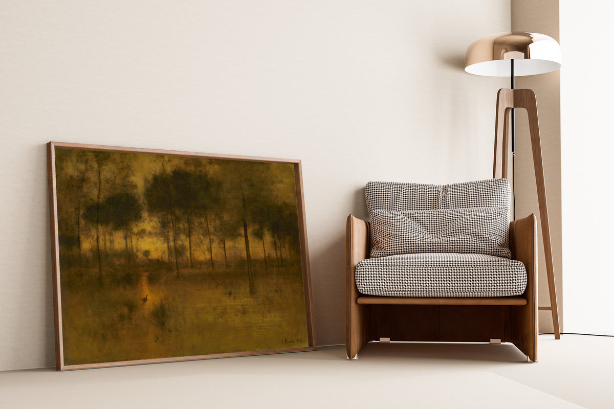 The Home of the Heron by George Inness — framed and leaning against a wall beside an armchair and a floor lamp