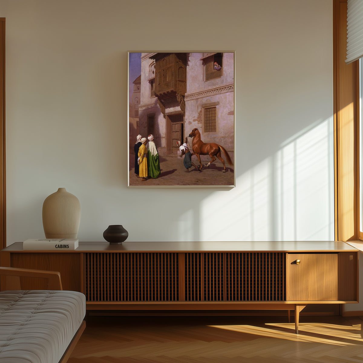 Framed art print of The Horse Market by Jean-Léon Gérôme, in a thin light frame on a sunlit wall above a wooden sideboard